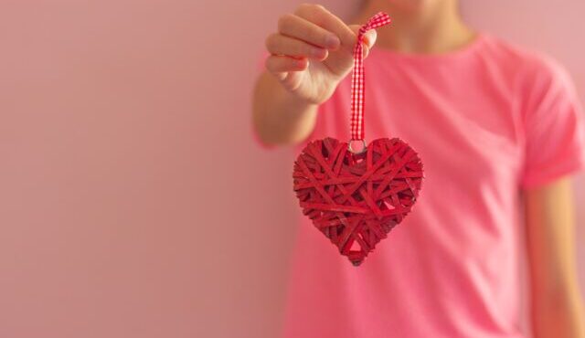 Girl holds heart-shaped jewelry concept of love valentine's day